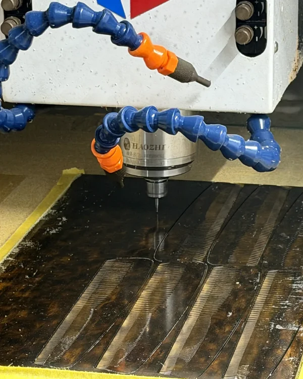 CNC spindle routing cellulose acetate comb profiles before finishing